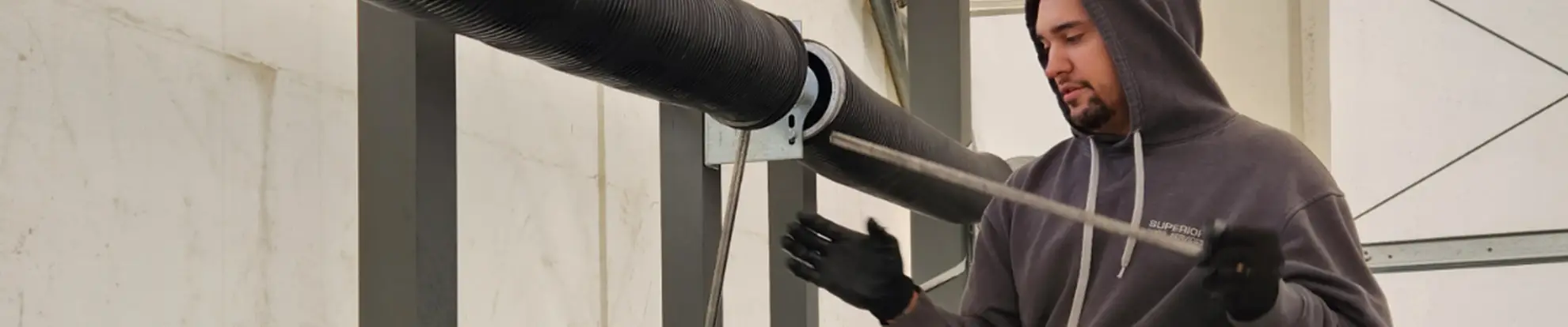 Garage door technician repairing a garage door
