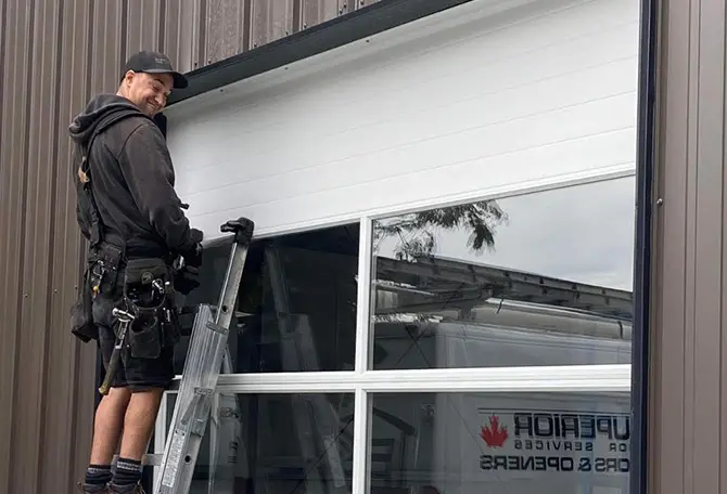 Technician finshing the installation of a garage door