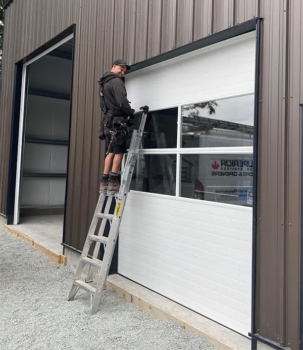 Technician finshing the installation of a garage door