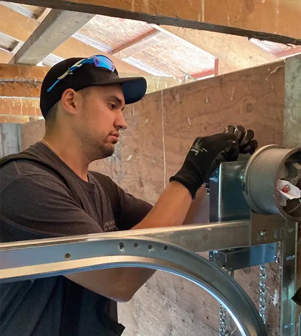 Garage door technician repairing a garage door